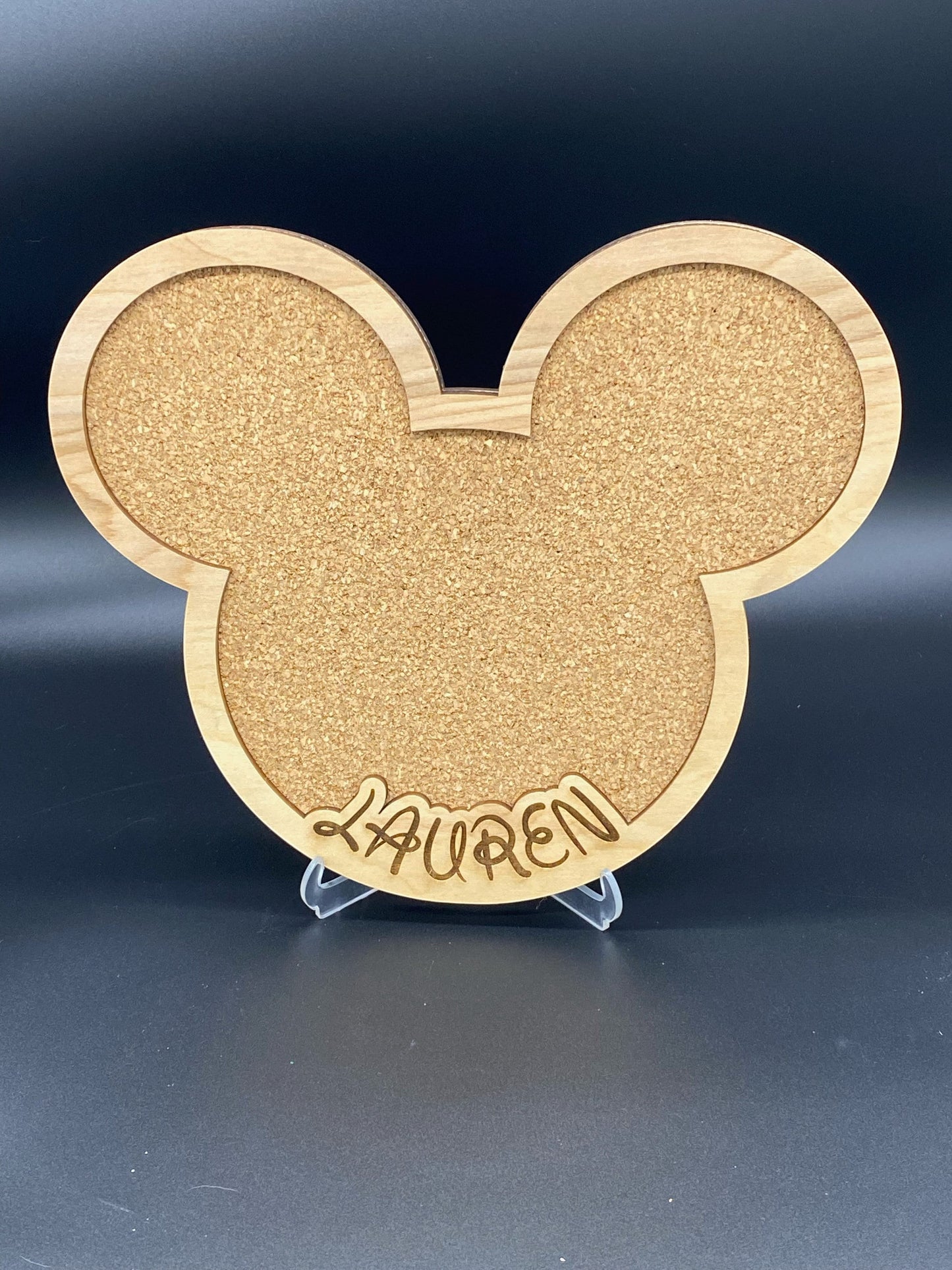 Freak of Laser personalized character-shaped cork pin display board with Lauren engraved on a light wood frame.